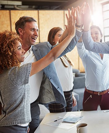 Employees high five each other Image of employees giving each other high fives